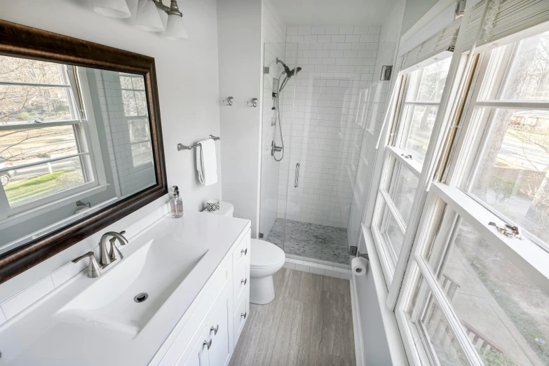 this bathroom has white tile and wood trim on the shower