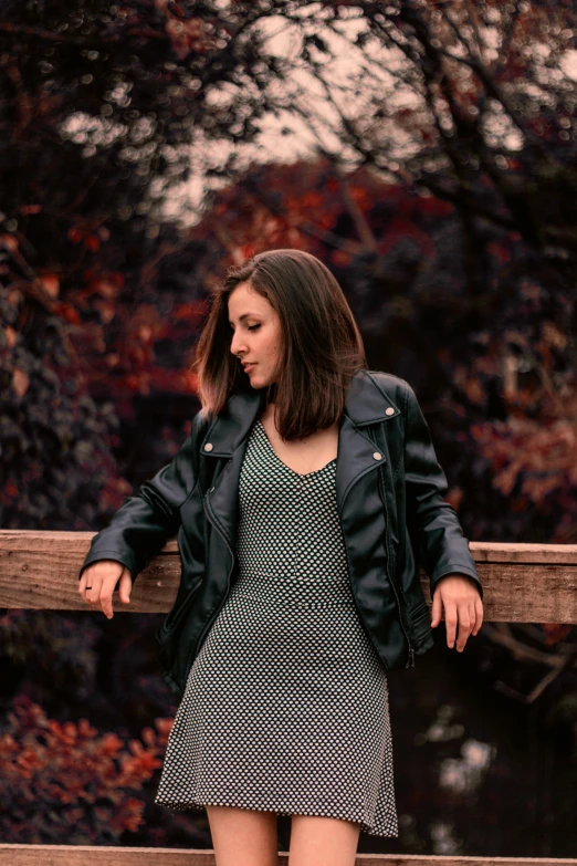 a young lady is looking down at her jacket