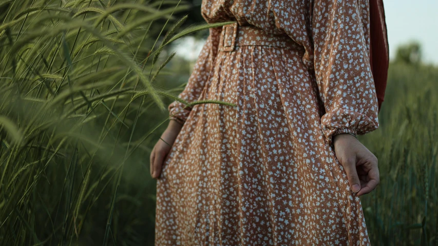 the back of a woman's dress with flowers and small hearts on the front