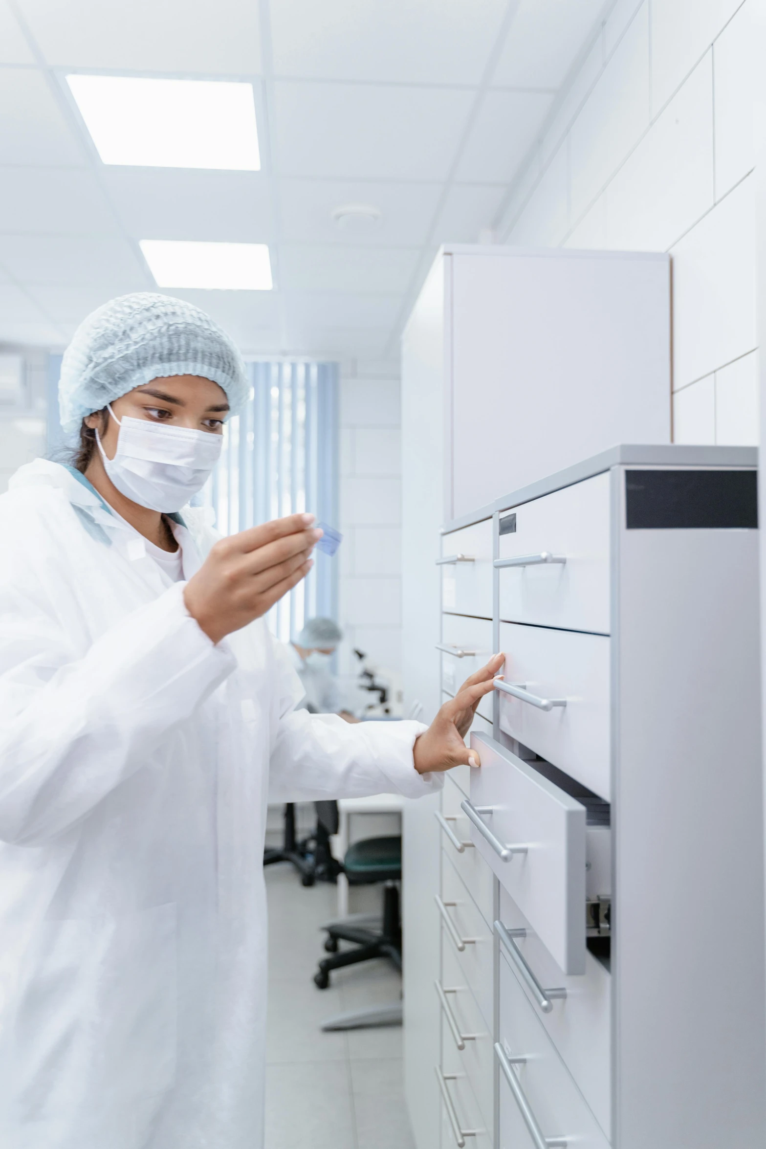 a male scientist in white shirt and face mask