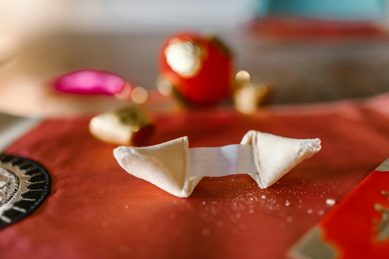 an origami piece on a red cloth on a table