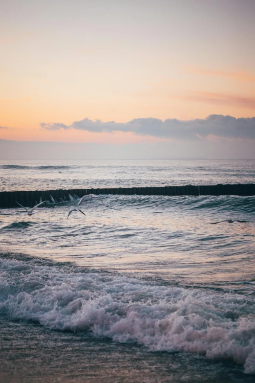 the ocean with crashing waves on a beach