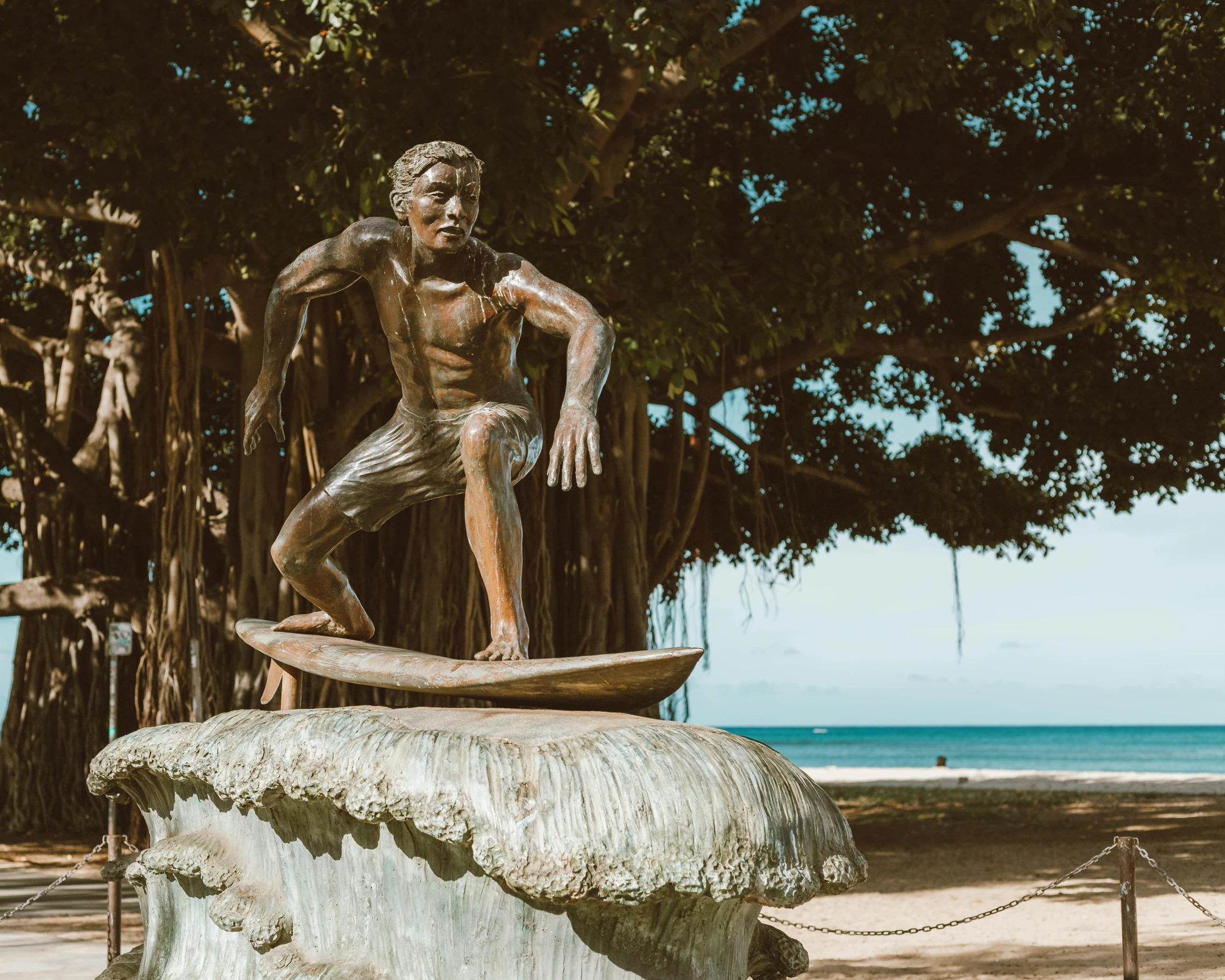 statue with skateboard and bare body sitting on a rock