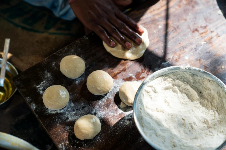 a person is rolling dough on a table