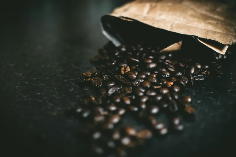 a bag of coffee beans spilled onto the ground