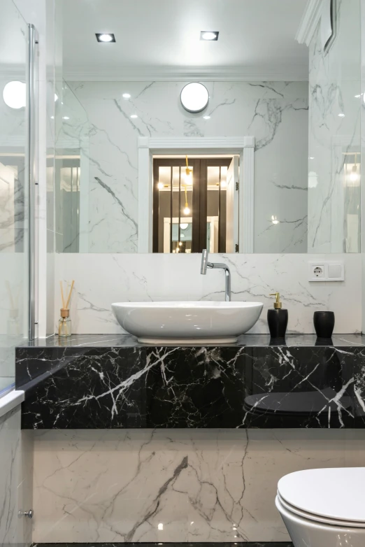 a bathroom with a sink, toilet and a window