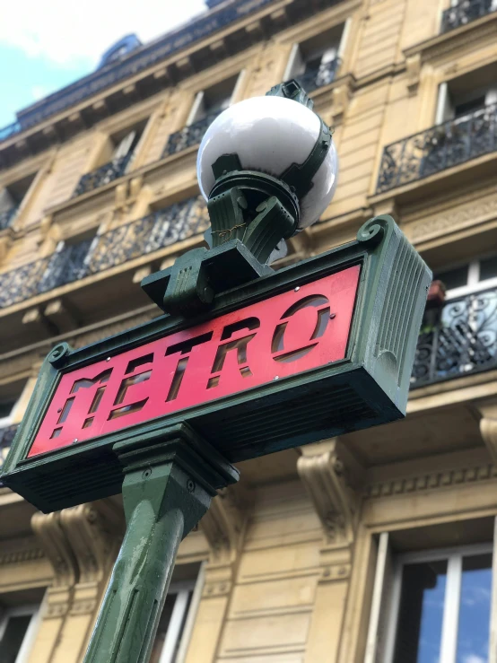 a sign that reads metro is hanging on a street pole