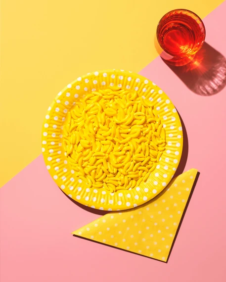 a yellow bowl sitting on top of a yellow and pink table