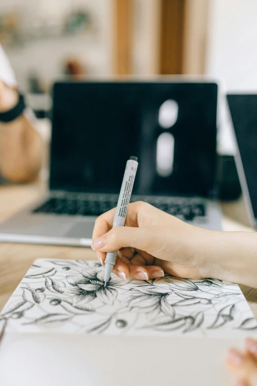 the woman is working on her sketch book