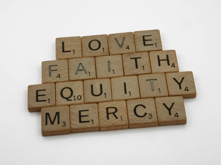 a scrabble font on a white background with words describing love, faith, and equity