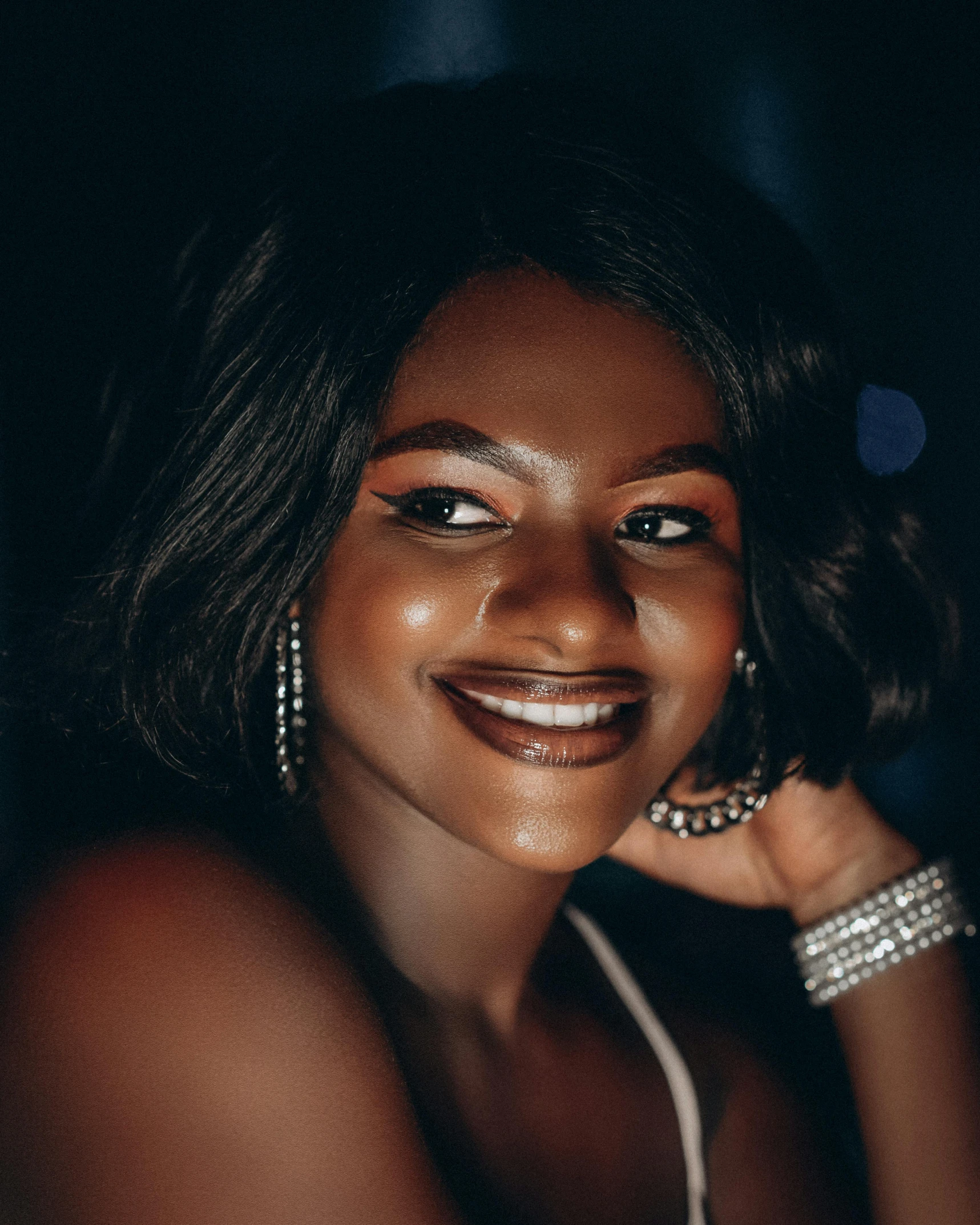 a woman with dark skin wearing ear rings