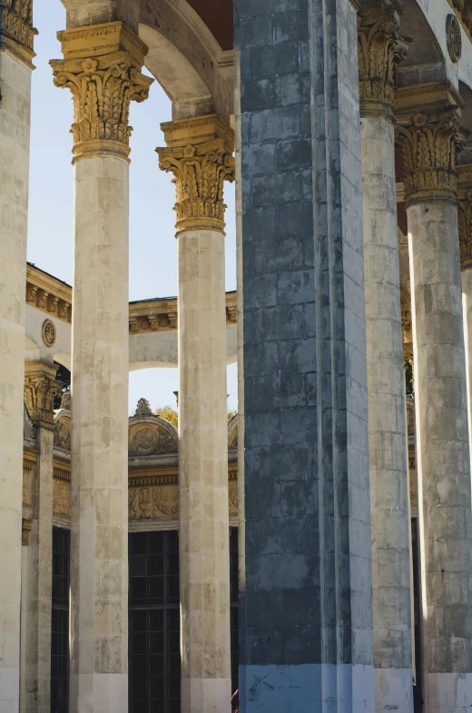 an old building with columns and pillars in the foreground