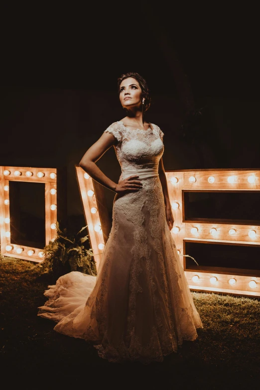 woman standing in front of a lighted letter sign