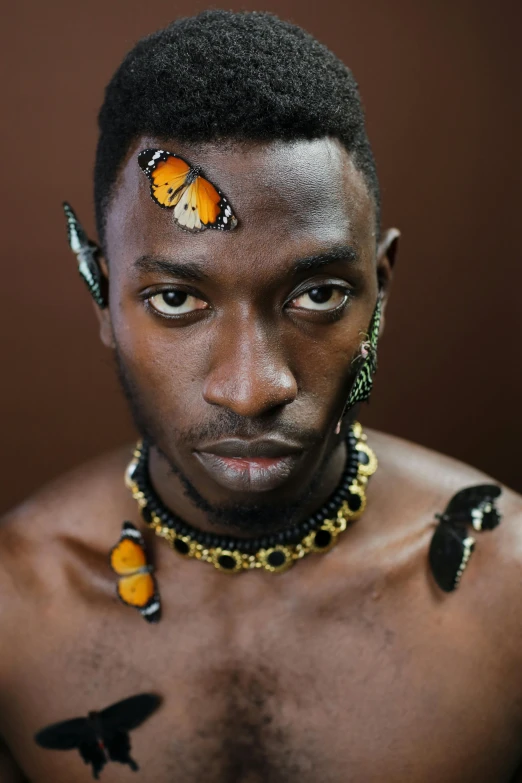 a young man with a erfly on his forehead