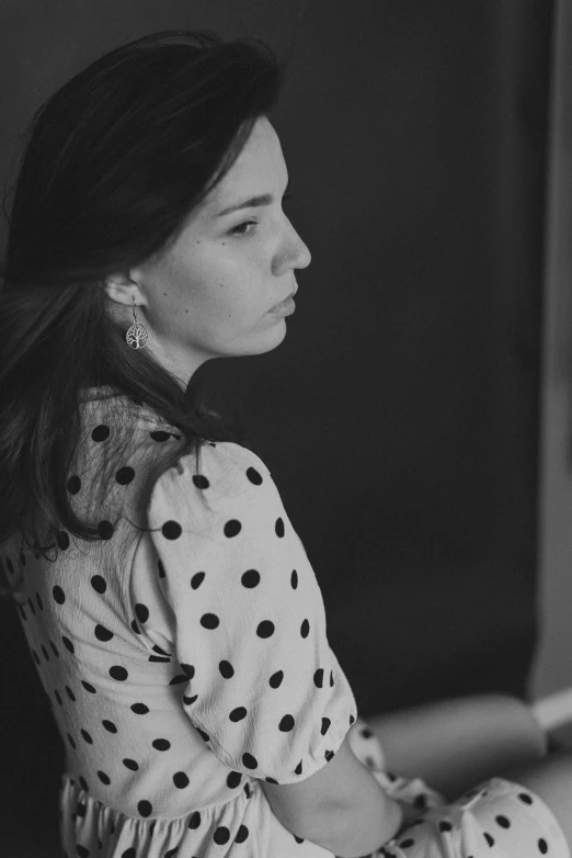 a woman is sitting down and posing for the camera