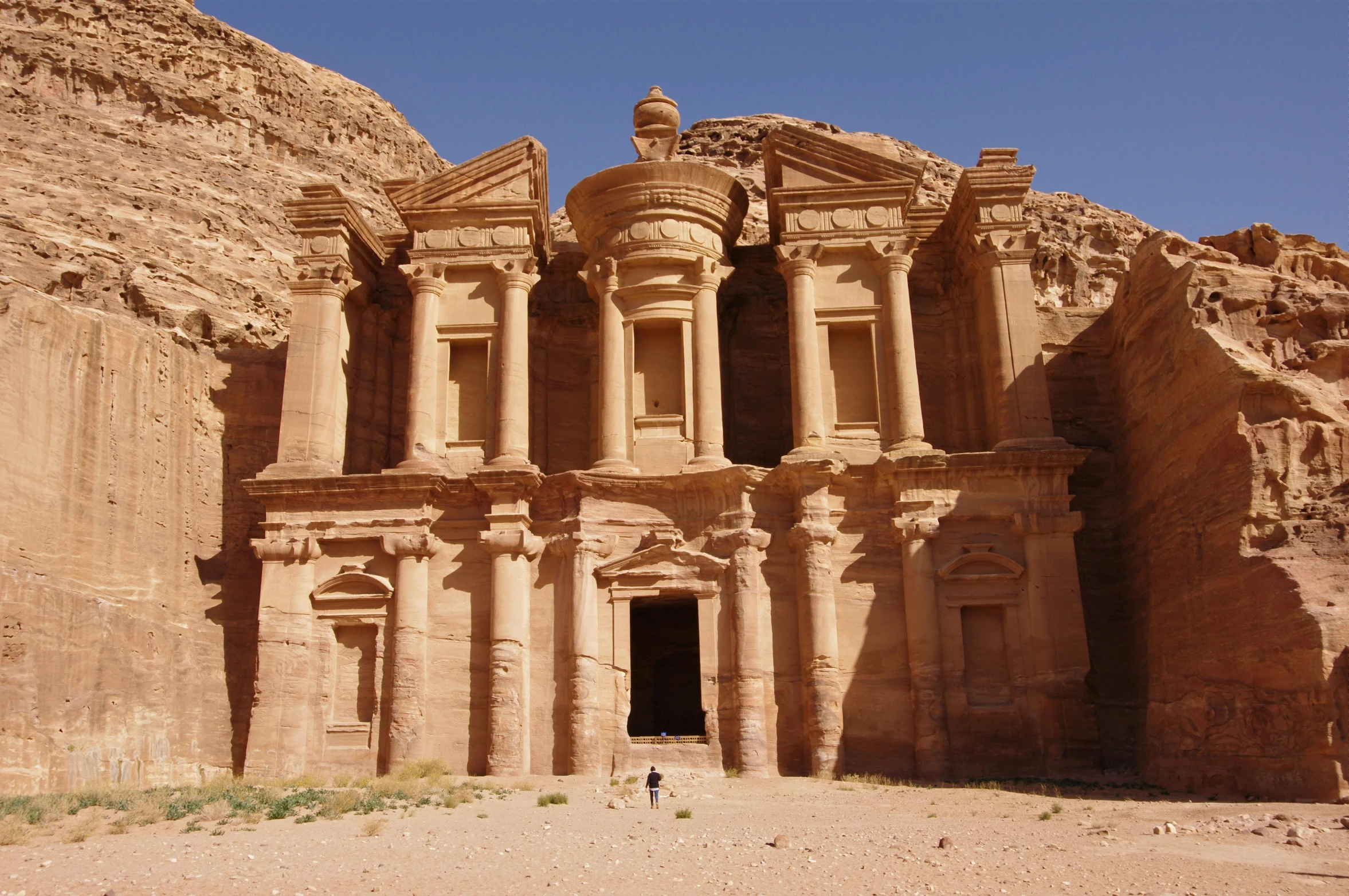 the doorway of an ancient building carved into a hill