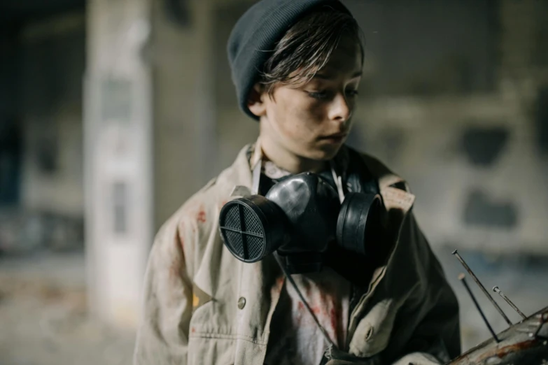 a person wearing gas masks holding a cell phone