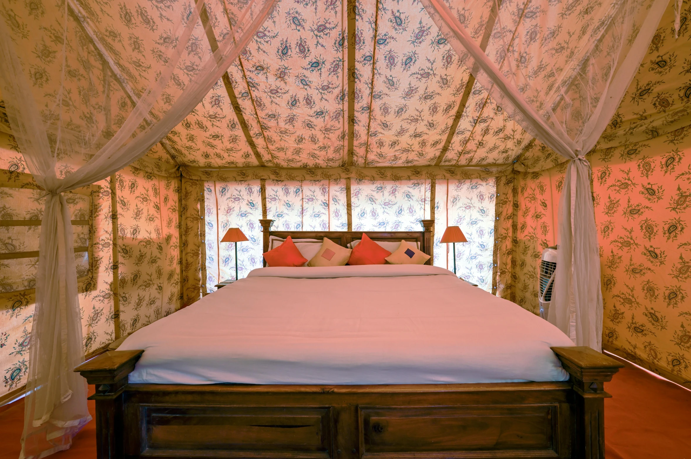 a bedroom with a white bed sitting inside of it