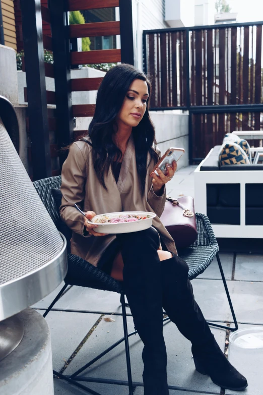 a woman sitting in a chair eating food