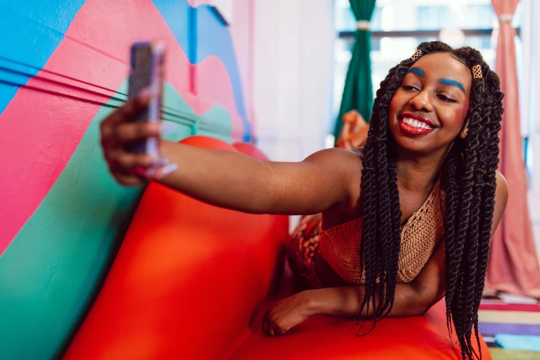 a beautiful woman sitting on top of a colorful bouncy ball