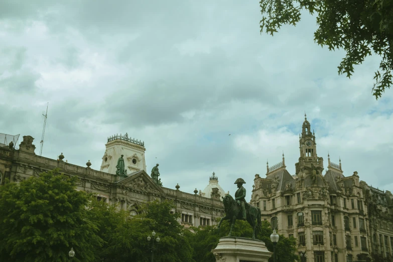 a tower in the back side of some large buildings