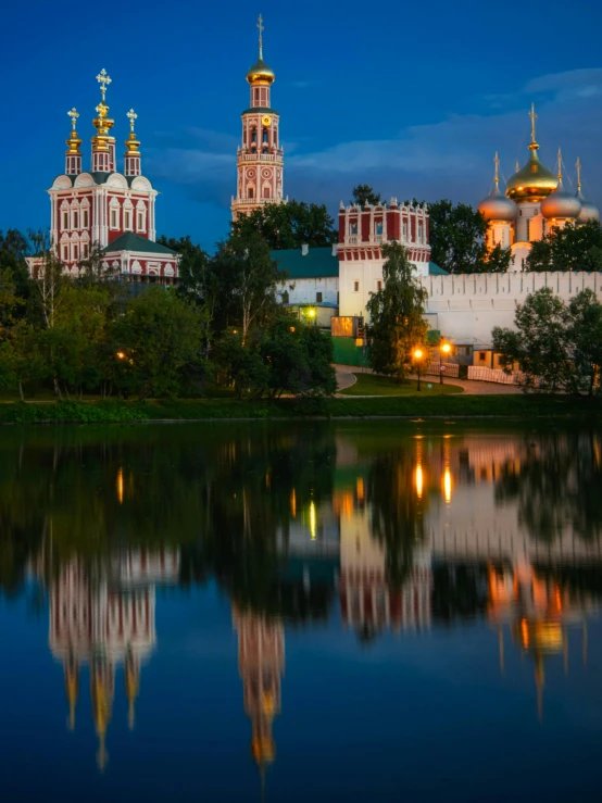 the large buildings are reflected in the water