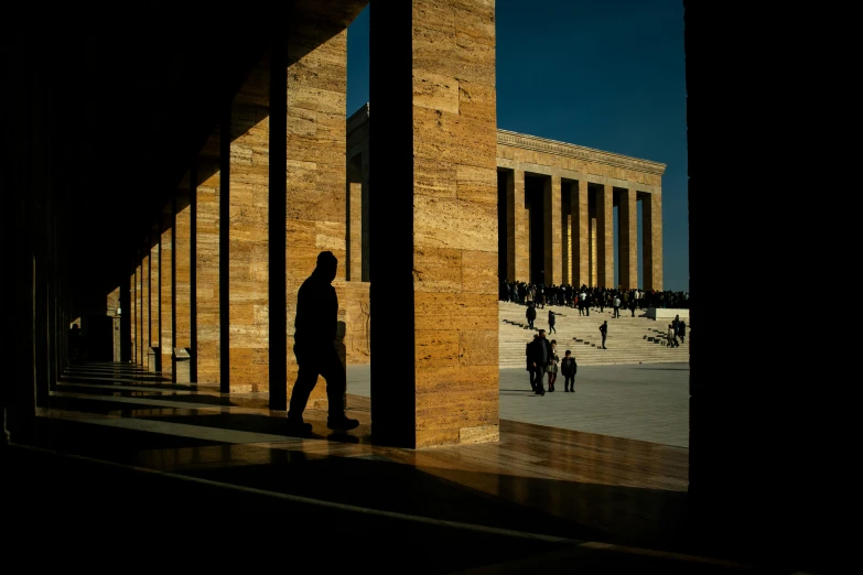 people are standing outside the national monument looking at the shadows