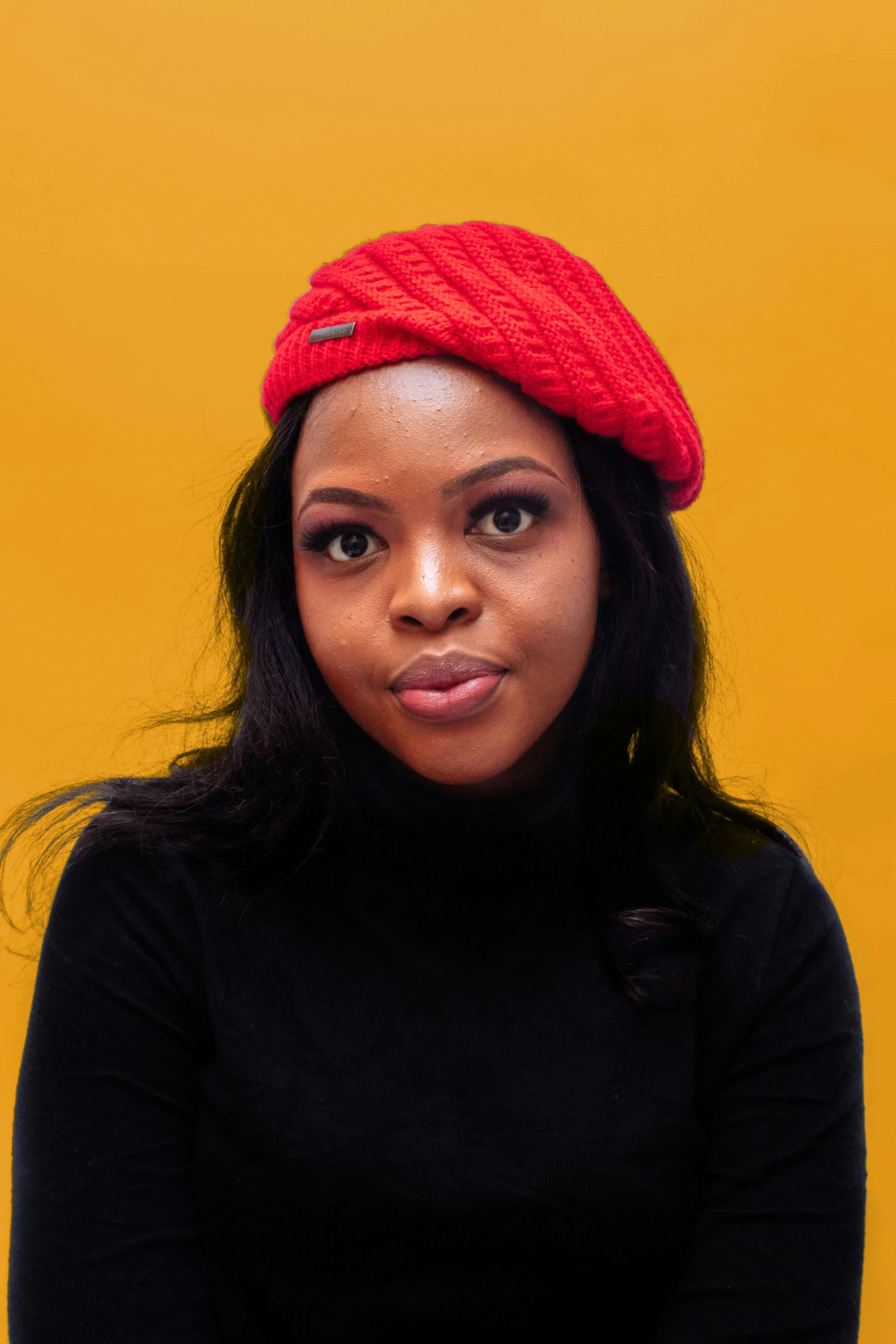 a woman in a red hat is posing for a po