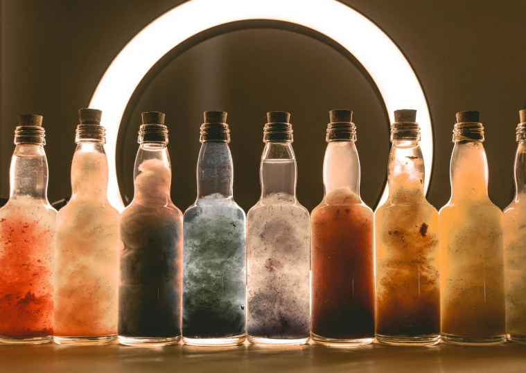 bottles of soda in a group lined up, on a table