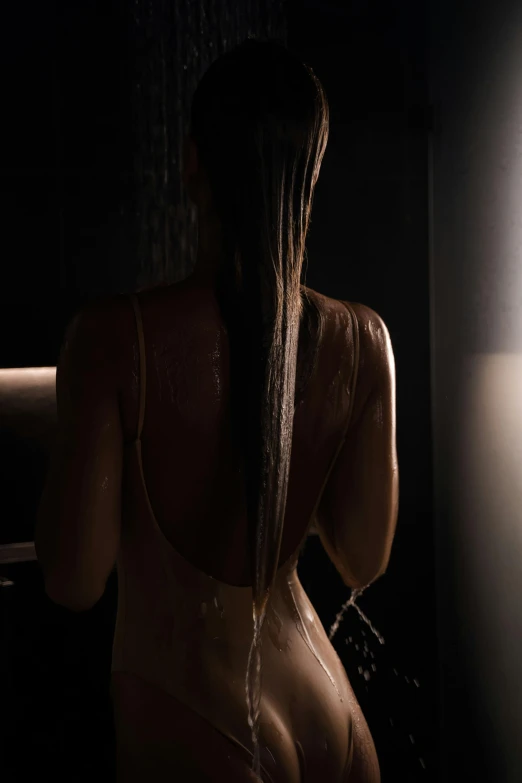 a  woman sitting in front of a bath tub