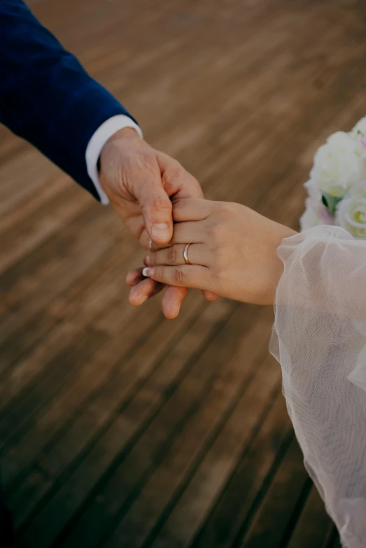 a close up of a person holding another person's hand