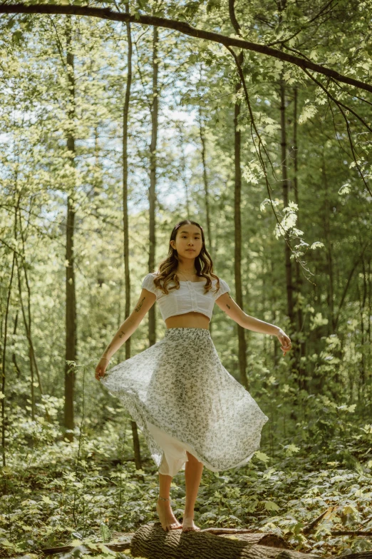 a  posing on a log in the woods