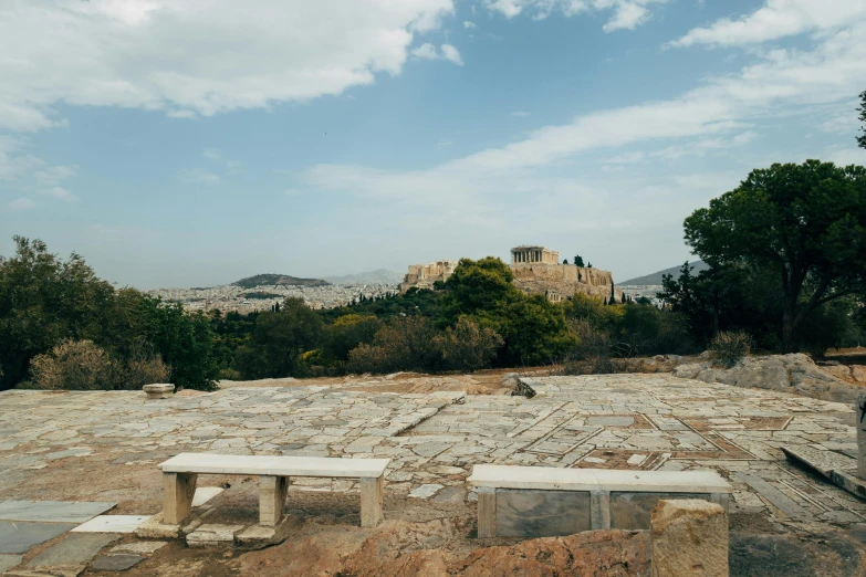 the two benches are up against the stone wall