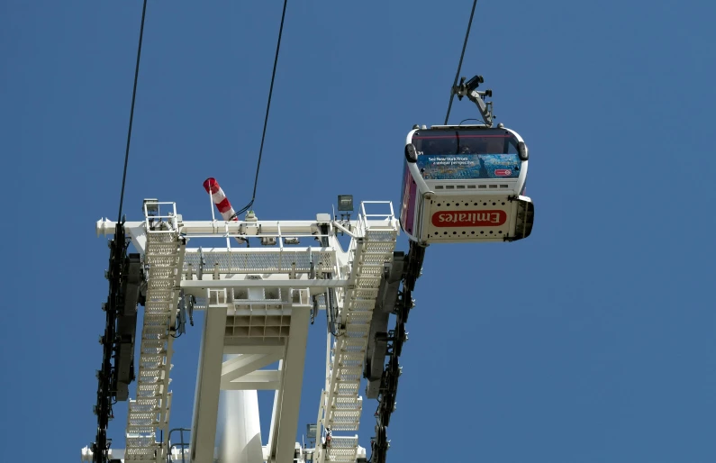 a cable car with a person on it is going down the mountain