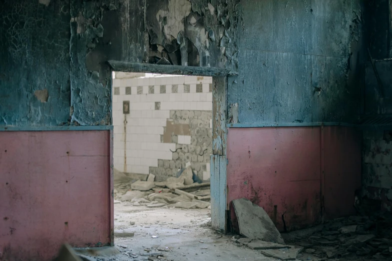 a dilapidated run down building with a very dirty door