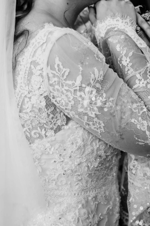 a bride poses for a po with her veil pulled over