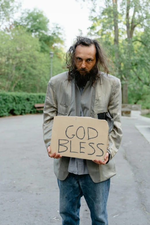 the man is holding a sign that says god blessing