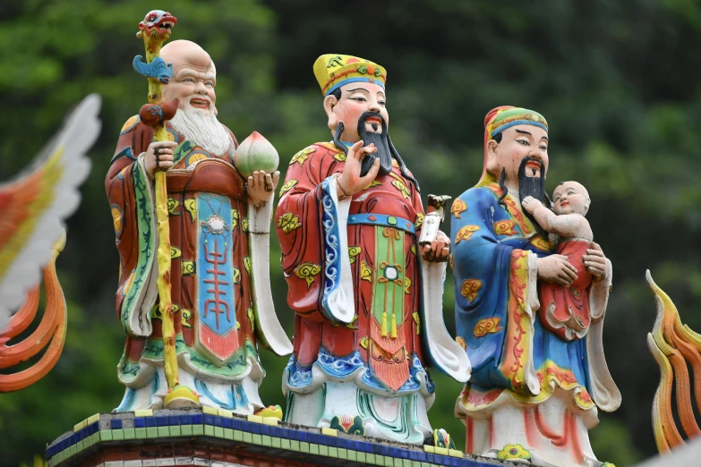 three statues that are sitting in front of each other