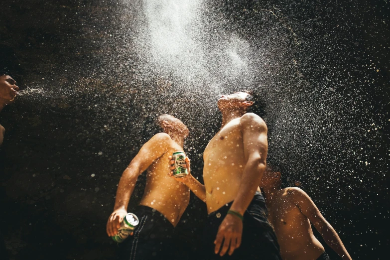 a pair of young men are playing in the rain