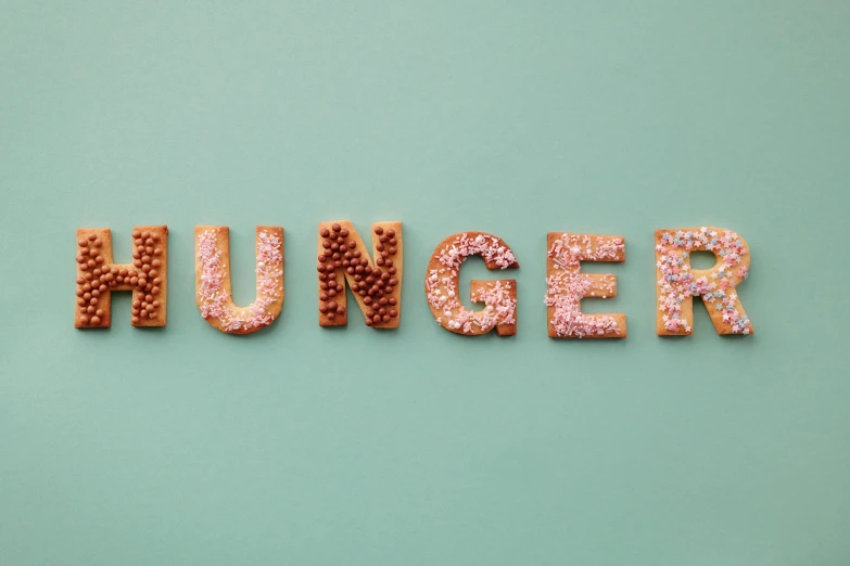 the word hungry written out of cookies on a green background
