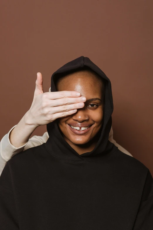 a woman showing the hand on top of her head