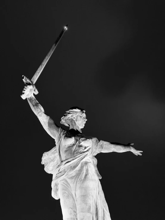 the statue looks very majestic, as he holds a baseball bat