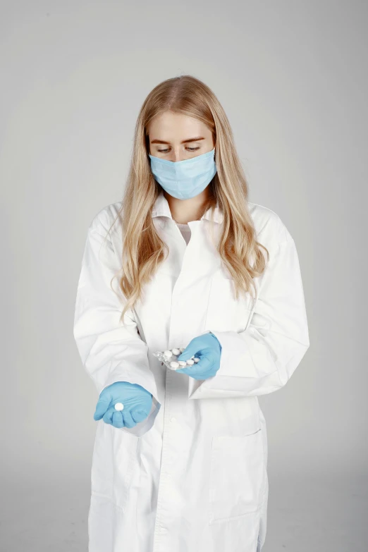 a female lab technician wearing a face mask and gloves