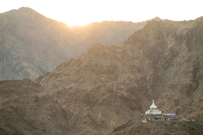 a mountain side that has a large structure on it