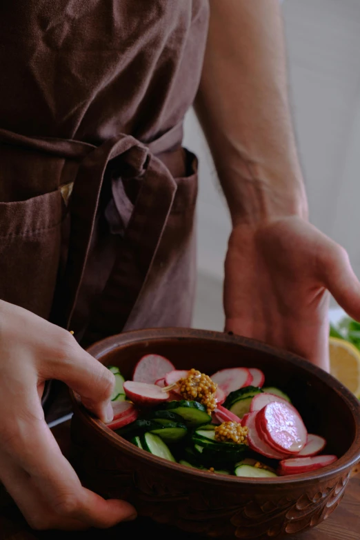 a person is holding a bowl of food