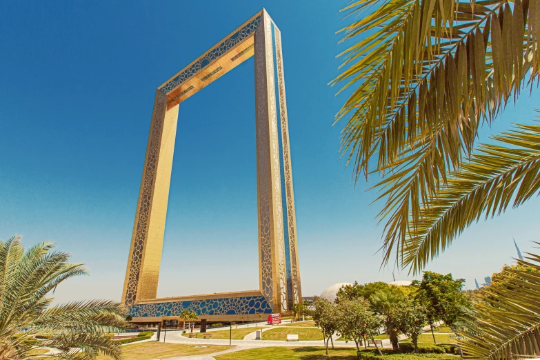 a tall monument with a palm tree in the foreground