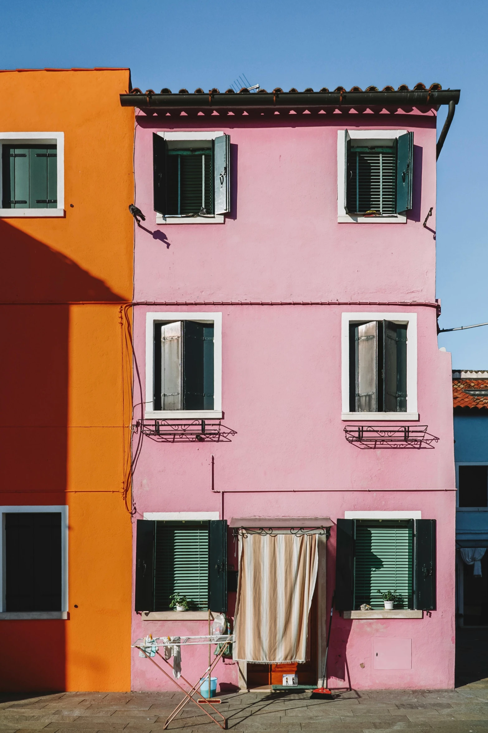 two very colorful buildings that are next to each other