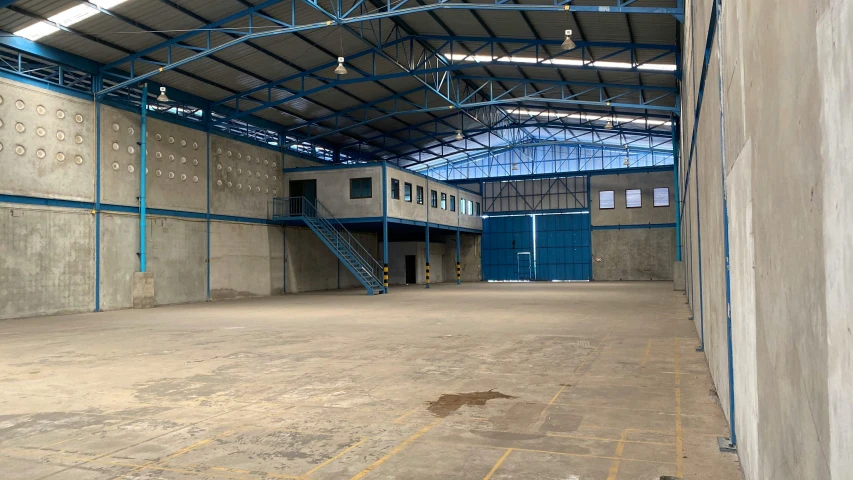 empty industrial building with blue accents and exposed duct