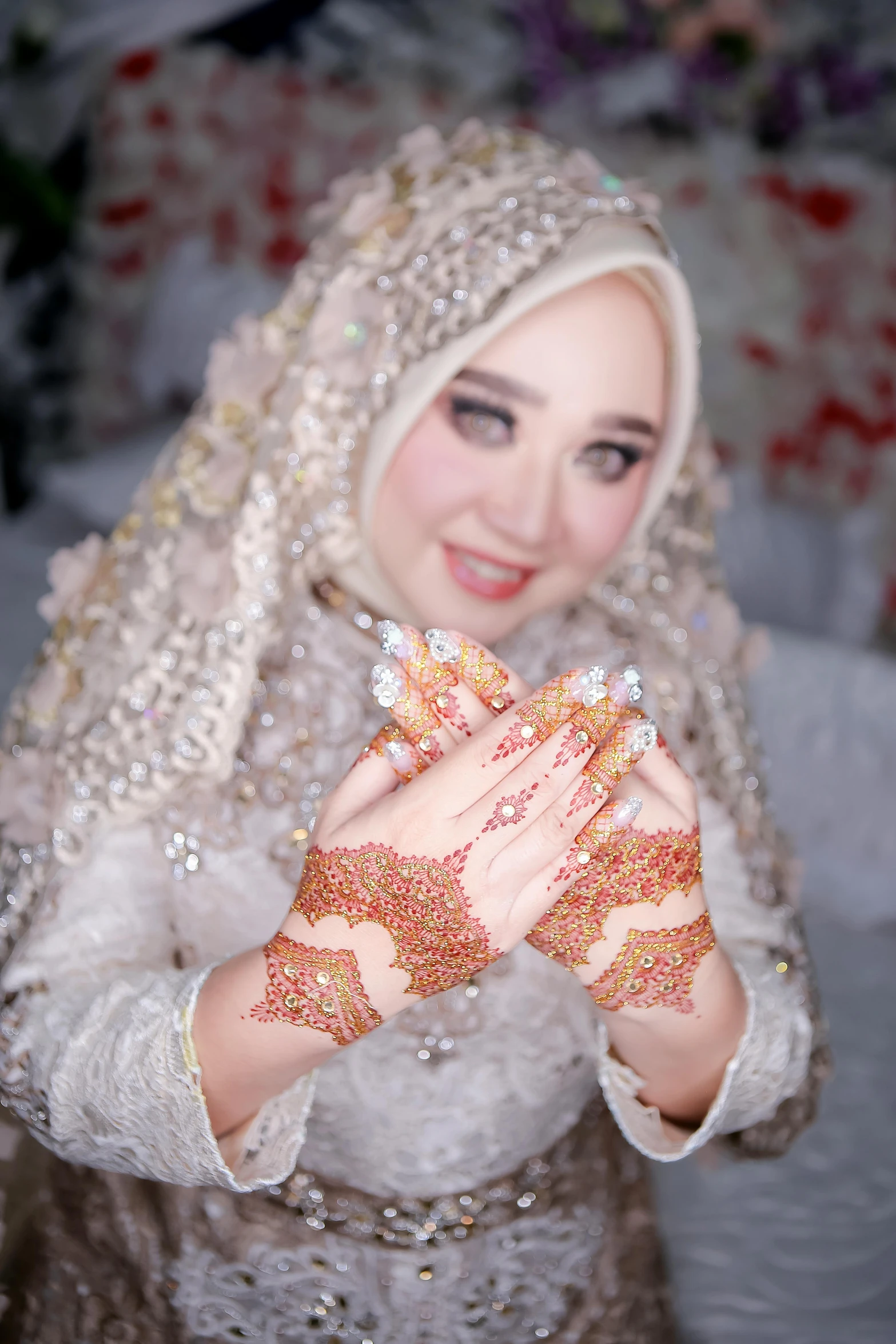 a young woman in a veil holds up her hands