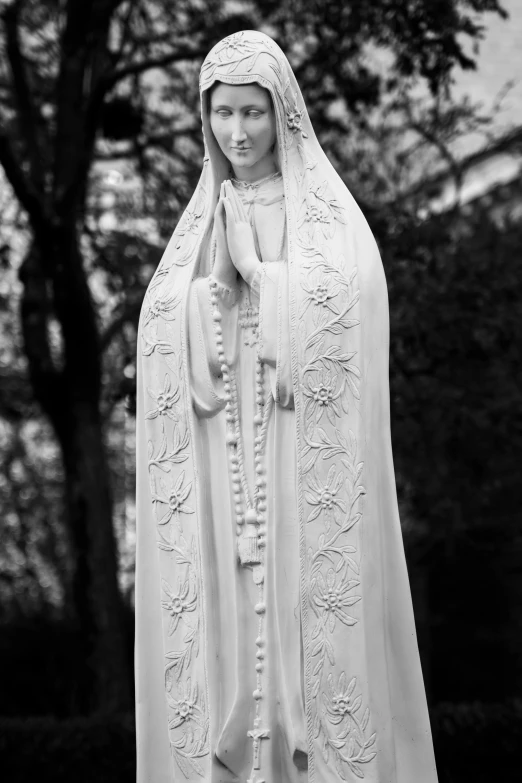 a black and white po of a statue wearing a veil